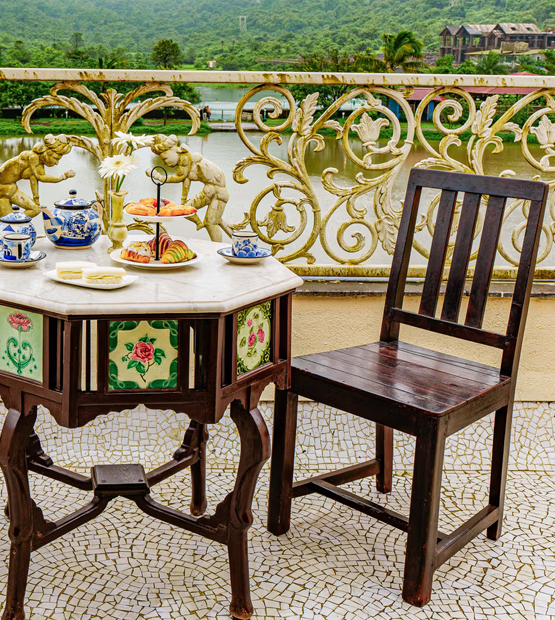 Outdoor high tea setup with scenic view at Patus Haven villa in Lonavala