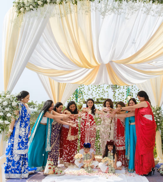 Family celebration at a villa in Lonavala with traditional decor and joyful moments under a floral canopy