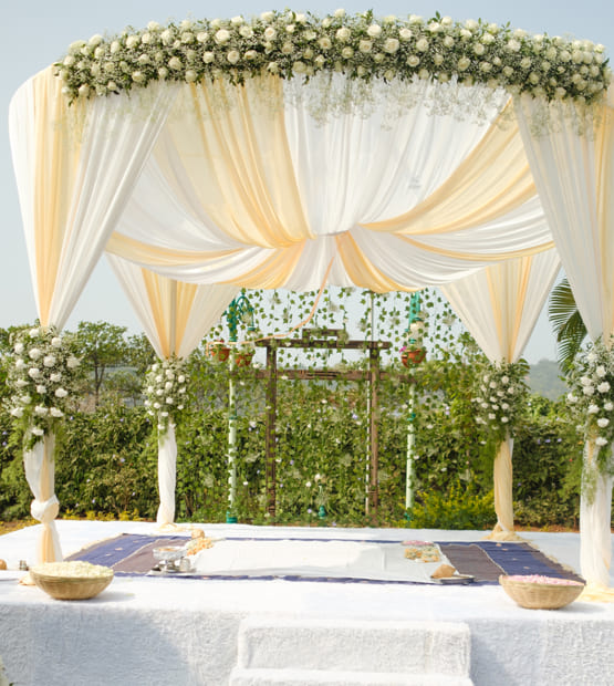 Scenic villa in Lonavala set up for a family event with floral arch and elegant seating