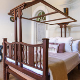 Elegant bedroom with curated amenities at a premium homestay in Lonavala offering comfort and style