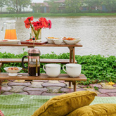 Outdoor seating with lakefront views at a luxurious villa in Lonavala offering a tranquil and serene atmosphere