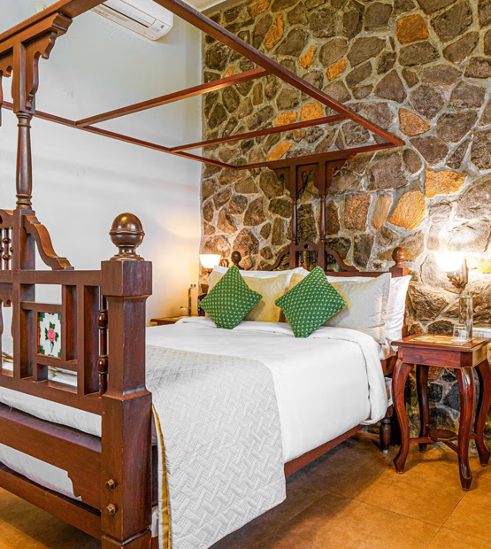 Luxury bedroom villa in Lonavala with stone wall decor